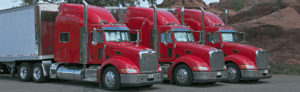 3 red trucks lined up with Commercial Truck Insurance in Atlanta