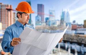 Construction working looking at blueprints with General Liability Insurance in Atlanta